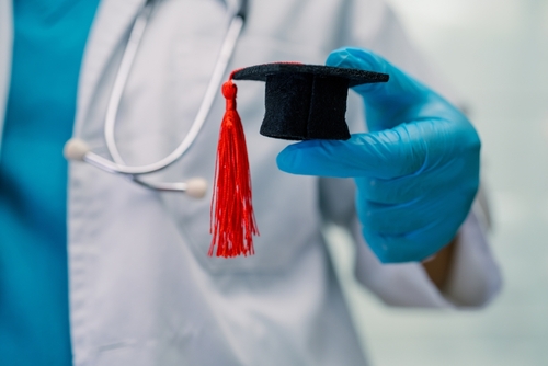 Doctor holding cap